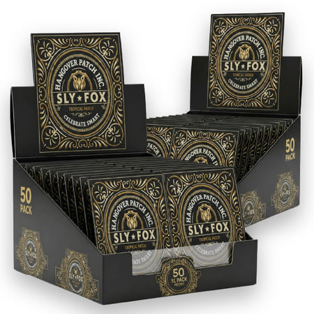A retail display box filled with Sly Fox brand rolling papers. The packaging is black with ornate gold detailing, featuring the Sly Fox logo and the text '50 PACK' and '50 PACK'.